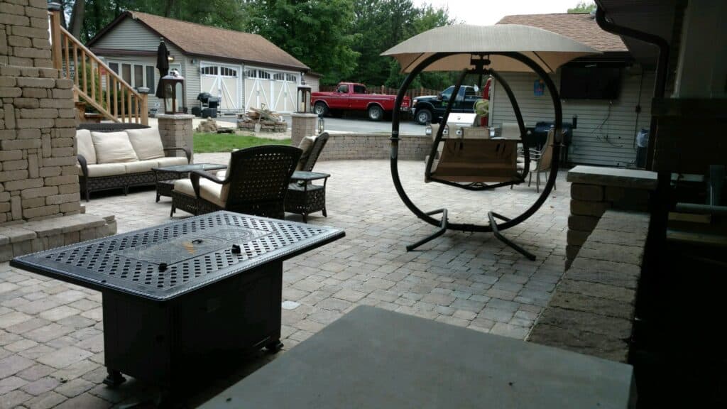 Finished paver patio with seat wall and fire table