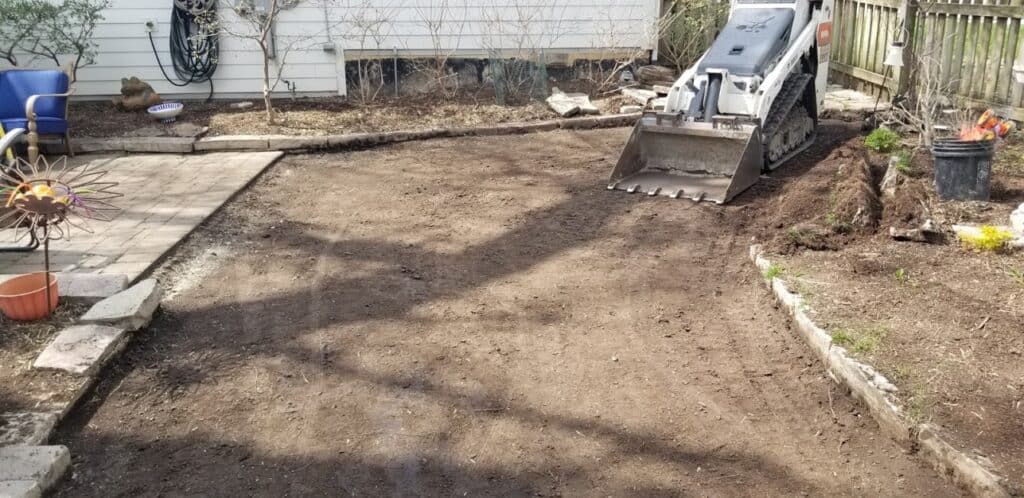 Backyard dug out with a skid steer for an artificial turf install