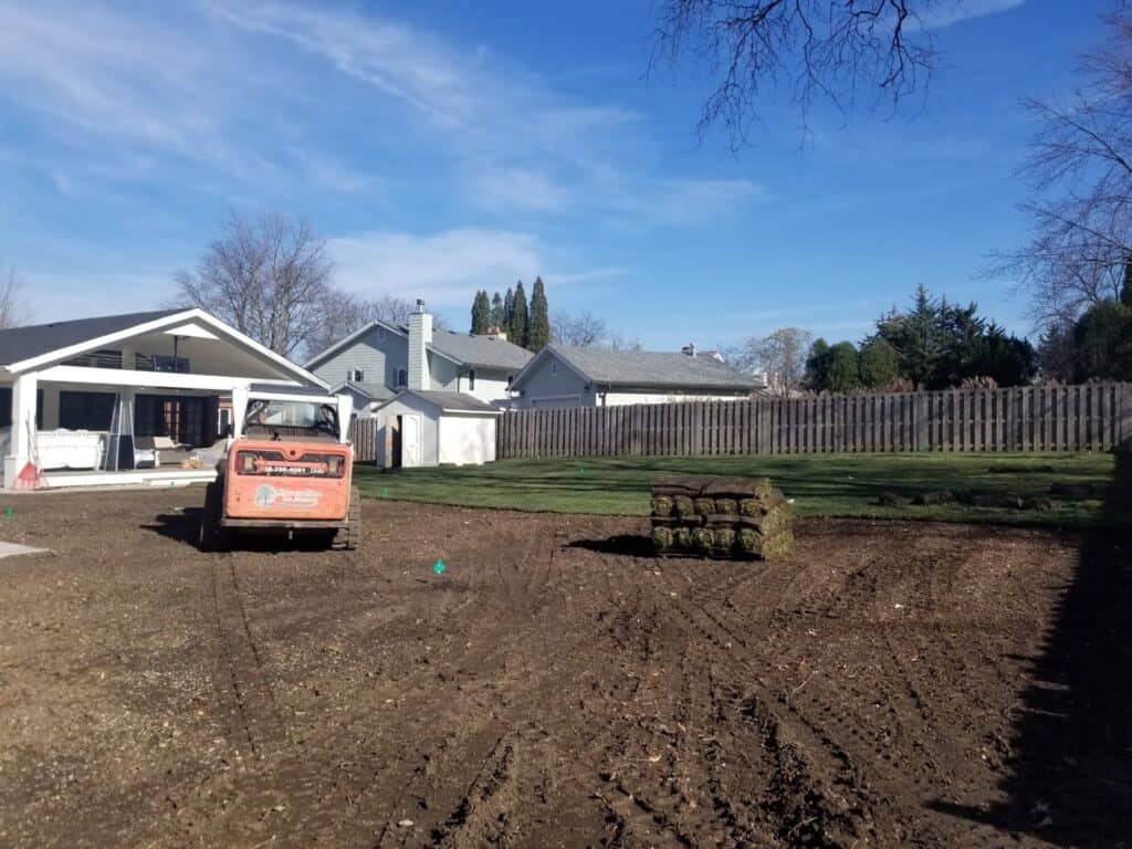 Pallets of sod delivered onto a freshly graded backyard