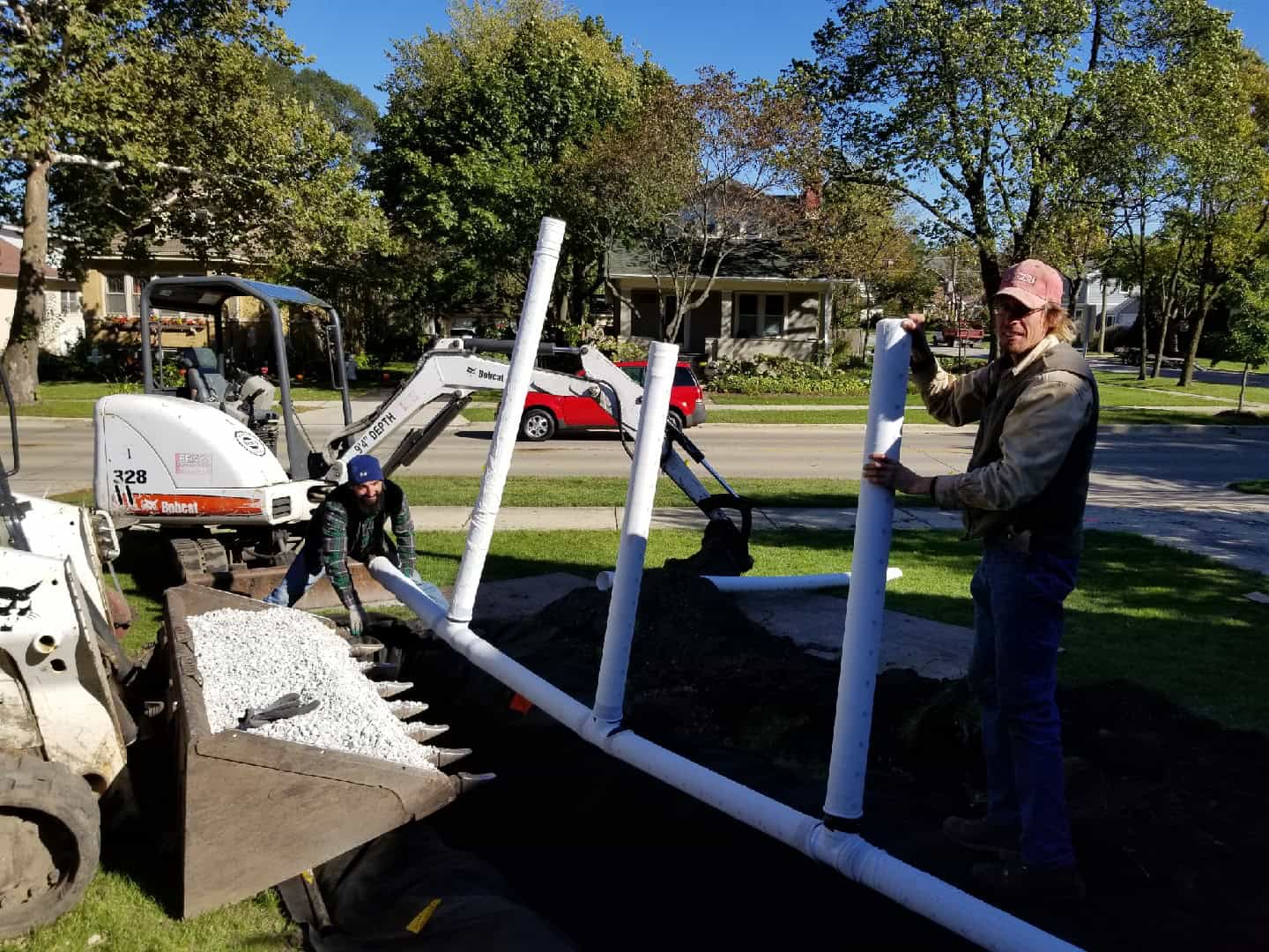 Streamline crew fitting underground drain pipe to carry sump water away from the house