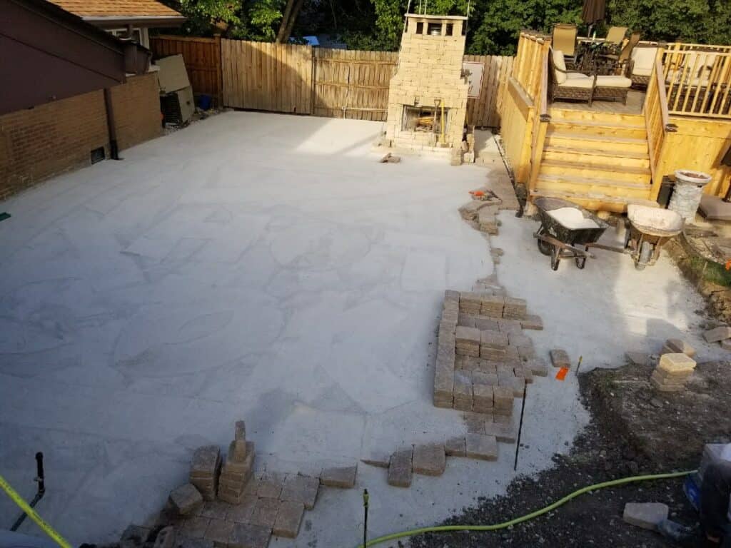 Backyard dug out and crushed stone base going down for a new paver patio