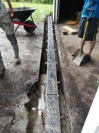 Channel drain being set into a concrete slab