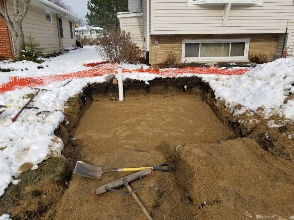 Streamline crew excavation underway with snow still on the ground