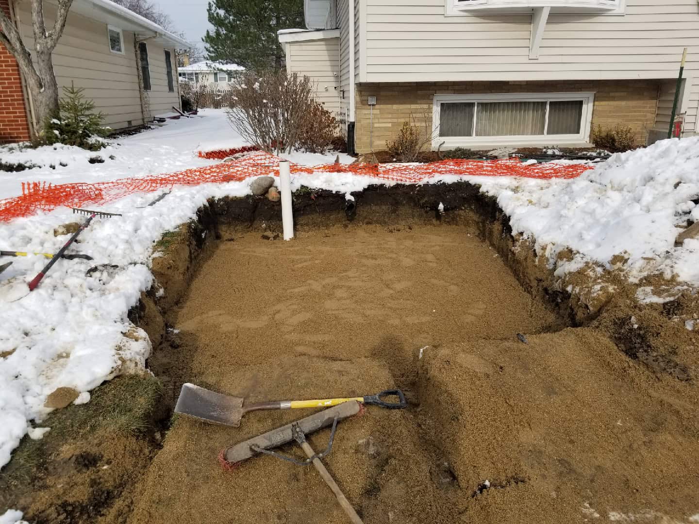 Streamline crew excavation underway with snow still on the ground