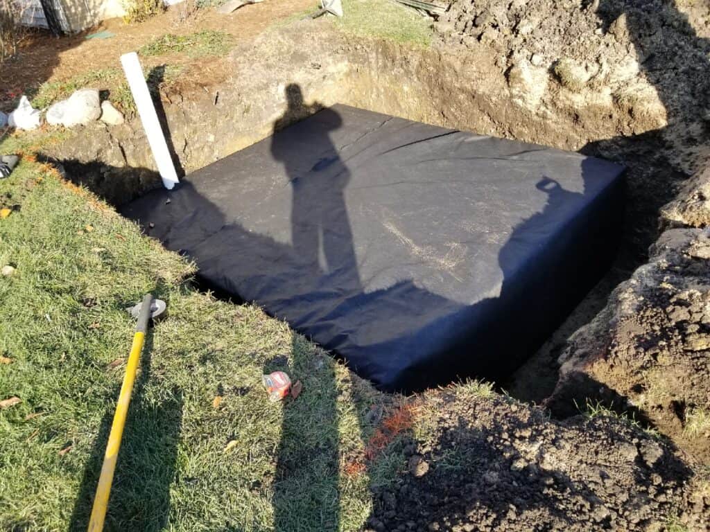 Dry well pit lined with filter fabric before the drainage chamber goes in