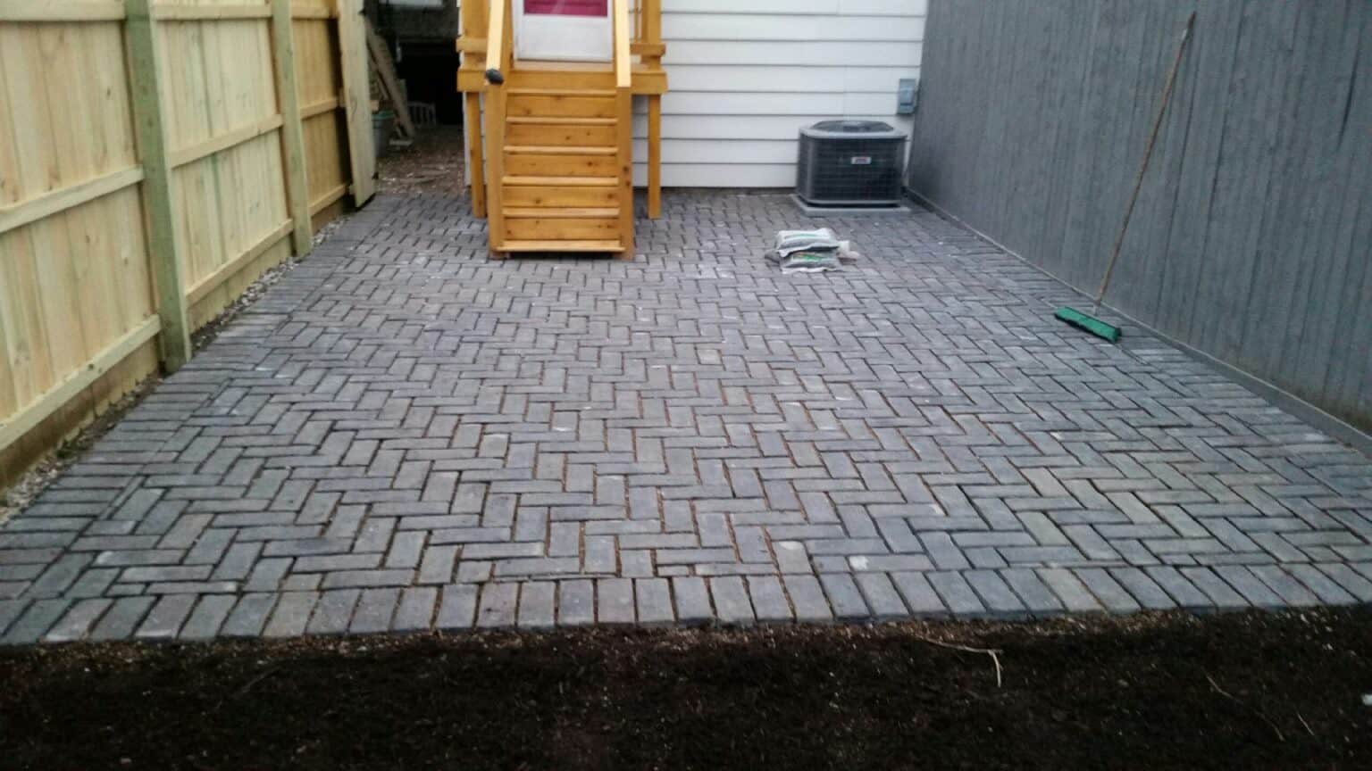 Permeable herringbone paver patio installed behind a Chicago-area home
