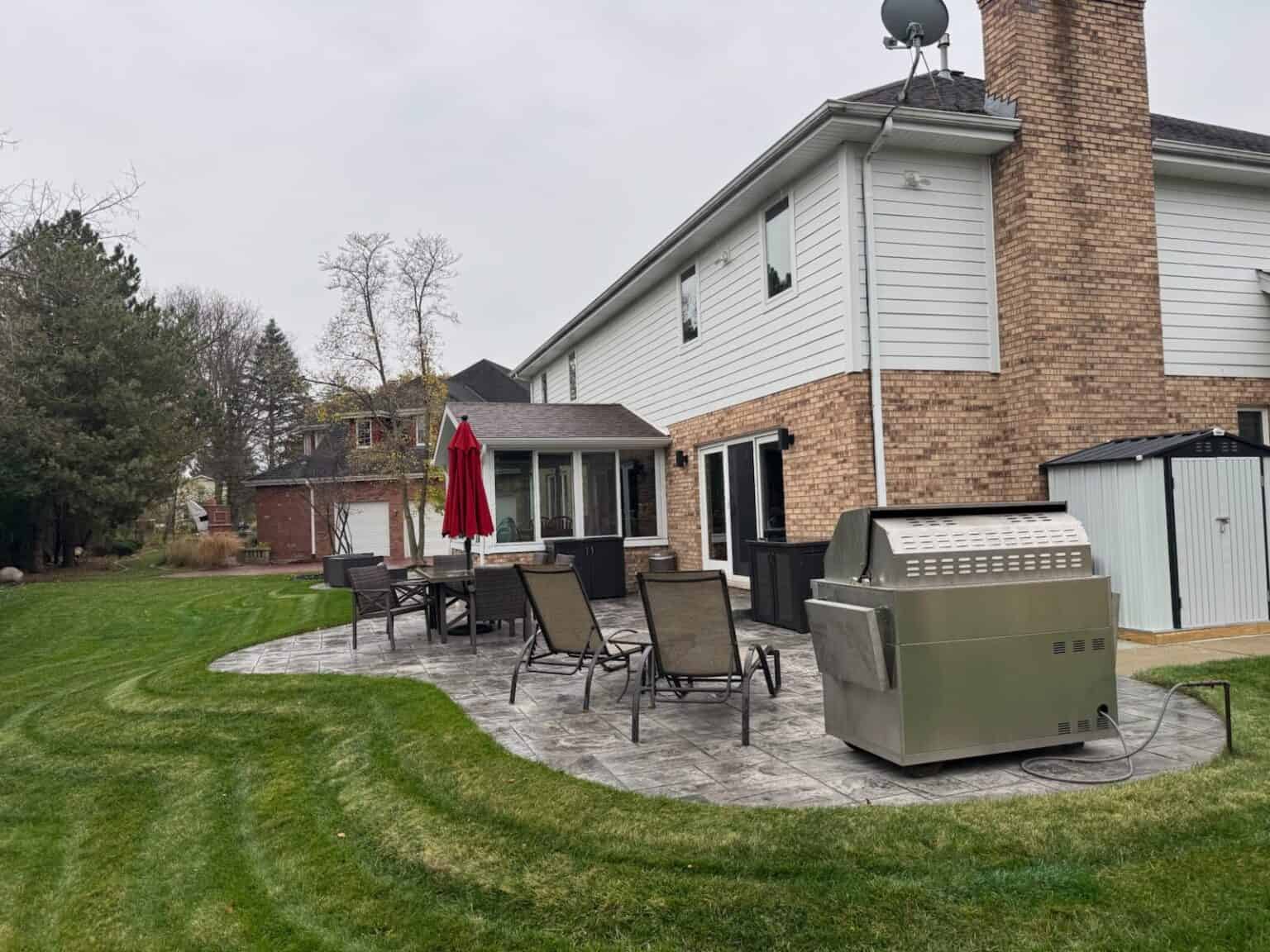 Stamped concrete patio seen from the corner of the yard